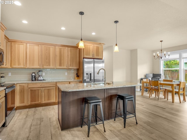 293 W Kershul Cir, Gearhart, OR 97138 - kitchen with stainless steel appliances, light wood finished floors, tasteful backsplash, and recessed lighting
