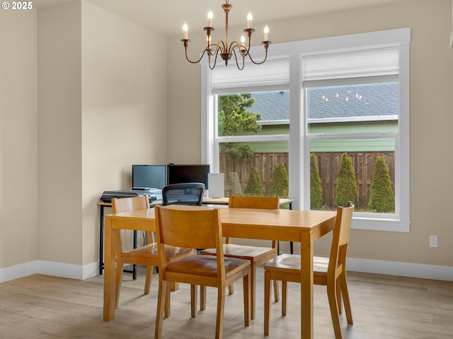 293 W Kershul Cir, Gearhart, OR 97138 - dining room with plenty of natural light, a chandelier, and light wood finished floors