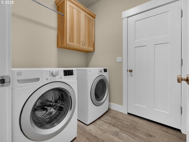 293 W Kershul Cir, Gearhart, OR 97138 - laundry area with washing machine and clothes dryer, light wood finished floors, and cabinet space