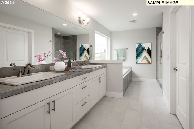 bathroom featuring vanity and independent shower and bath