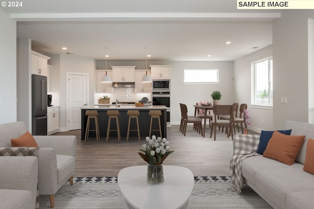 living room with hardwood / wood-style floors and sink