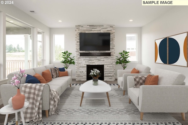 living room featuring a healthy amount of sunlight, wood-type flooring, and a fireplace