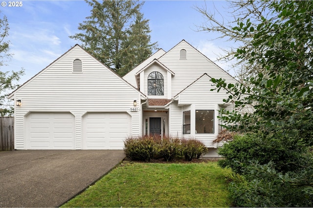 view of front facade featuring aphalt driveway, a front yard, and an attached garage