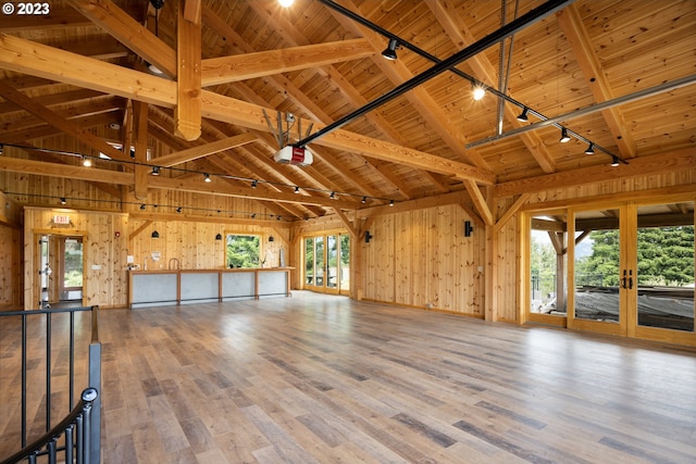 miscellaneous room featuring wooden walls, light hardwood / wood-style floors, french doors, and wooden ceiling