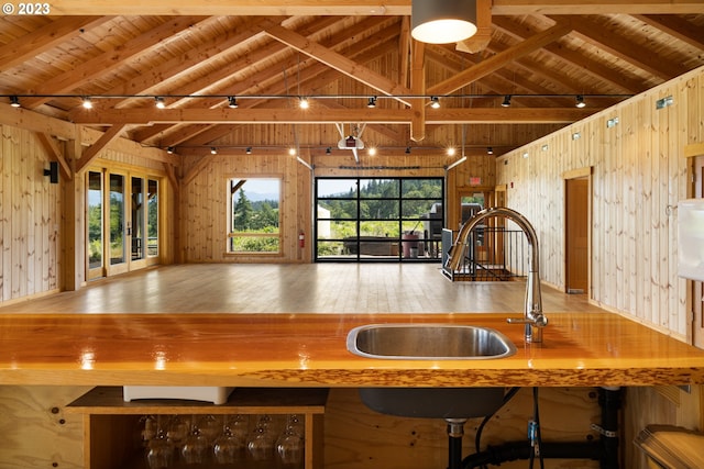 kitchen with plenty of natural light, wooden ceiling, and wood walls