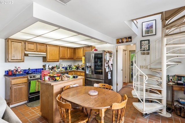 kitchen with stainless steel fridge and range