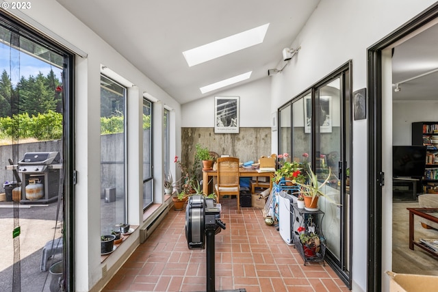 sunroom featuring lofted ceiling with skylight and a baseboard radiator