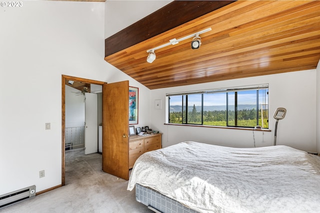 carpeted bedroom featuring wood ceiling, baseboard heating, rail lighting, and vaulted ceiling