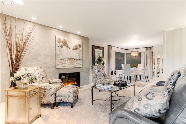 living room featuring light carpet and a large fireplace