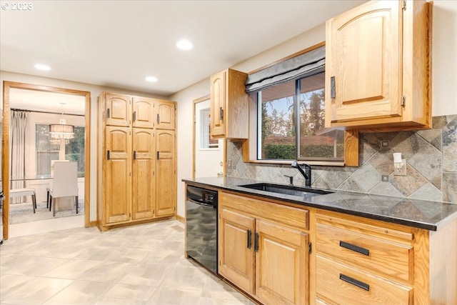 kitchen with backsplash, sink, black dishwasher, light brown cabinetry, and light tile patterned flooring