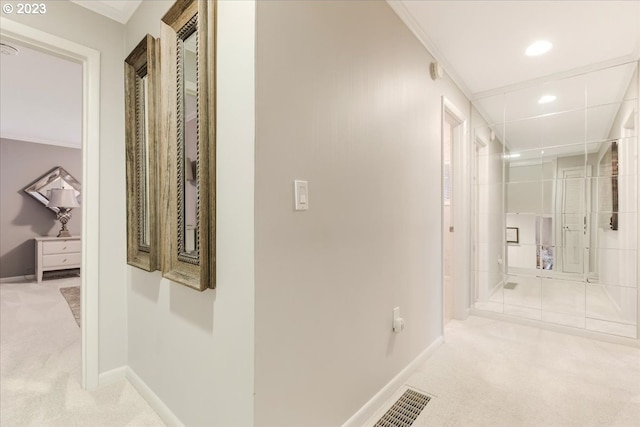 hall featuring light carpet and ornamental molding