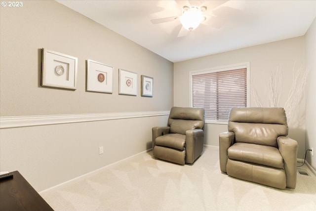 sitting room with light carpet and ceiling fan