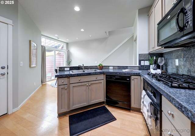 728 NE 72nd Ave, Hillsboro, OR 97124 - kitchen featuring black appliances, a peninsula, decorative backsplash, recessed lighting, and light wood-style flooring