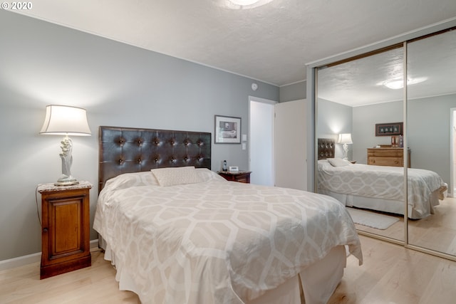 bedroom featuring a closet and light hardwood / wood-style flooring