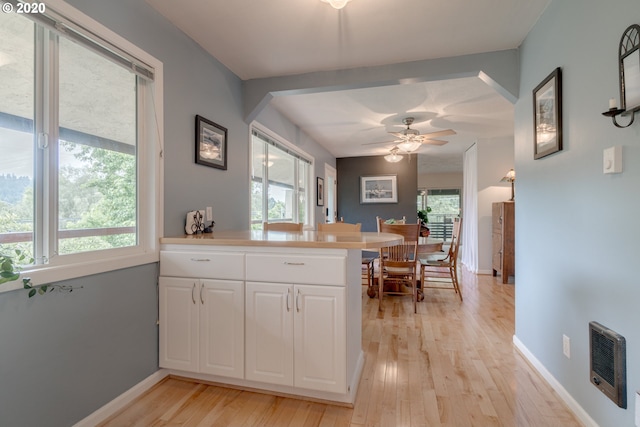 kitchen featuring plenty of natural light, ceiling fan, and white cabinetry