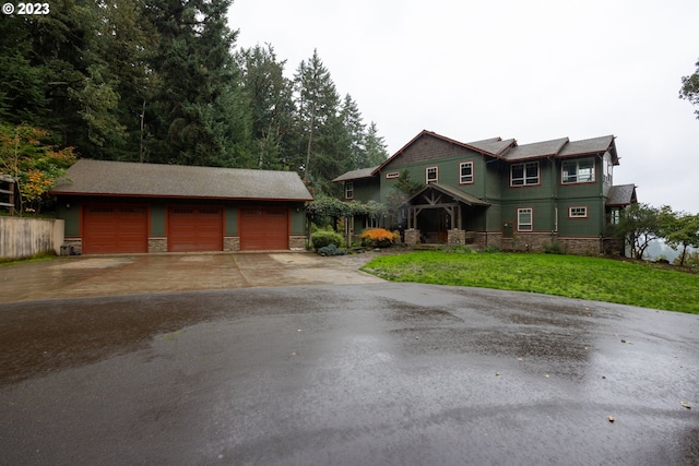 view of front of property with a front lawn and a garage