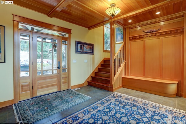 foyer featuring wood ceiling and tile patterned flooring