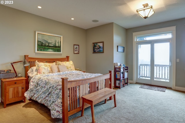 bedroom with access to outside and light carpet