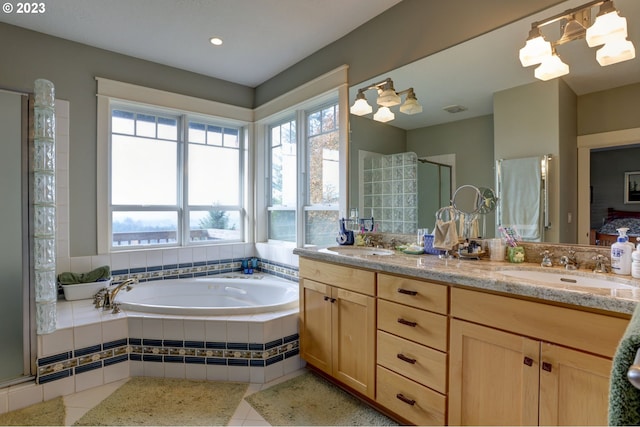 bathroom featuring independent shower and bath and vanity