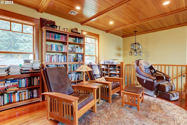 living area featuring beamed ceiling, light wood-type flooring, and wooden ceiling