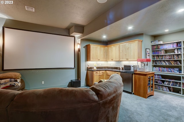 carpeted home theater with a textured ceiling