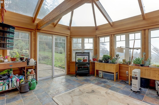 sunroom / solarium with heating unit and lofted ceiling with skylight