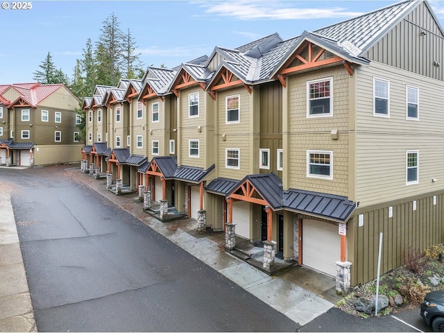 87916 E Alpenglow Ln, Government Camp, OR 97028 - view of front of home featuring a standing seam roof, board and batten siding, a residential view, metal roof, and a garage