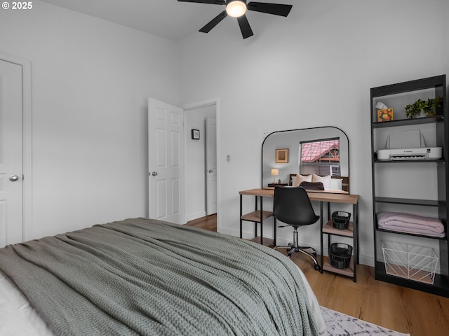 87916 E Alpenglow Ln, Government Camp, OR 97028 - bedroom with wood finished floors, a desk, a towering ceiling, a ceiling fan, and baseboards