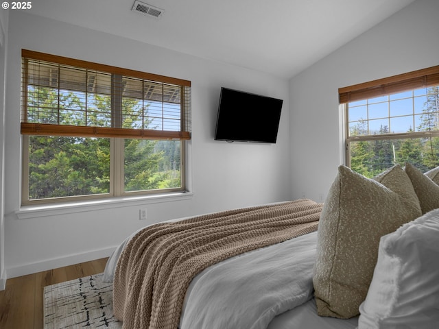 87916 E Alpenglow Ln, Government Camp, OR 97028 - bedroom with multiple windows, wood finished floors, vaulted ceiling, and baseboards