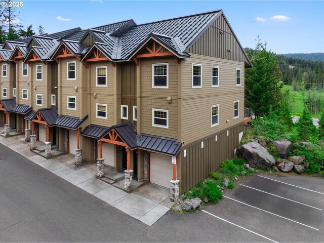 87916 E Alpenglow Ln, Government Camp, OR 97028 - view of front of home featuring board and batten siding, a standing seam roof, metal roof, and a garage