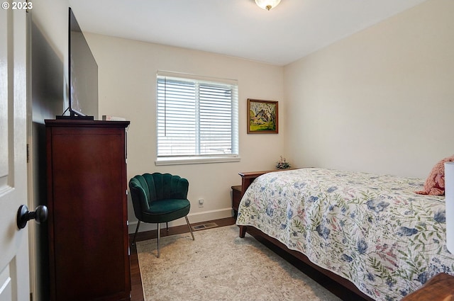 bedroom featuring visible vents and baseboards