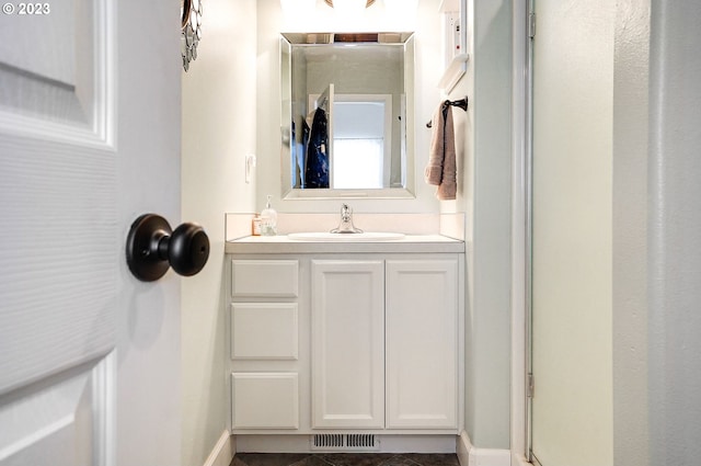 bathroom with vanity, baseboards, and visible vents