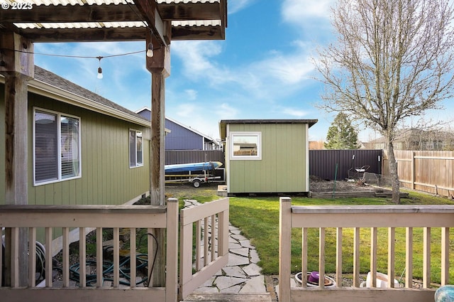 view of yard featuring a storage shed, an outbuilding, a trampoline, and fence