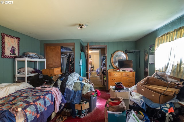 bedroom with a closet and dark colored carpet