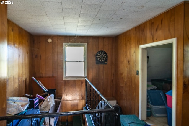 misc room featuring wooden walls