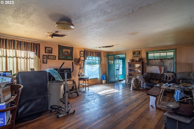 living room featuring a textured ceiling and dark hardwood / wood-style floors