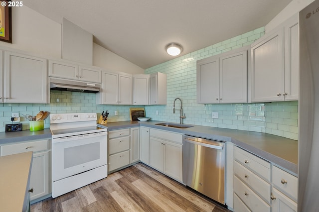 38225 Hiagua Ln N, Nehalem, OR 97131 - kitchen with white electric range, dishwasher, under cabinet range hood, lofted ceiling, and tasteful backsplash