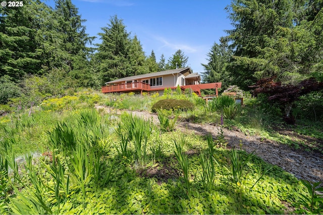 38225 Hiagua Ln N, Nehalem, OR 97131 - view of yard featuring a wooden deck and a wooded view