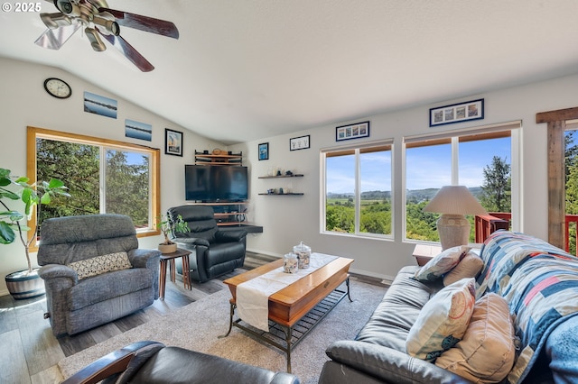 38225 Hiagua Ln N, Nehalem, OR 97131 - living area featuring healthy amount of natural light, lofted ceiling, wood finished floors, and a ceiling fan