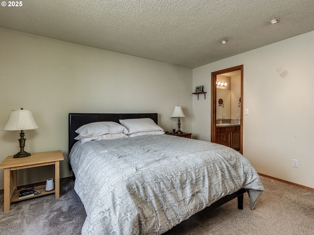 bedroom featuring baseboards, connected bathroom, and carpet