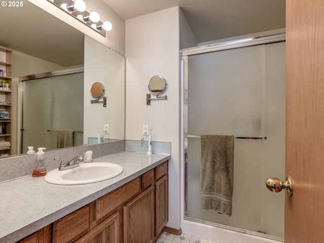 full bathroom with a shower stall and vanity