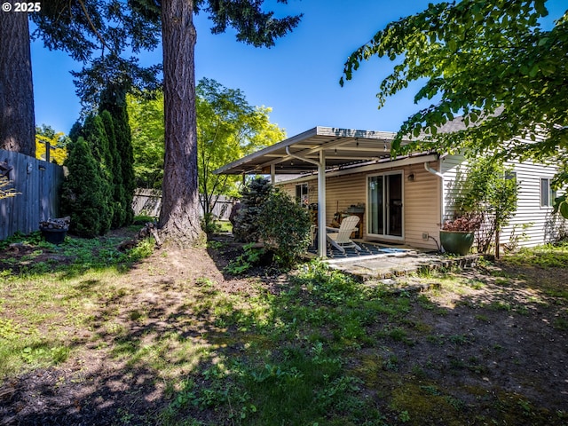 rear view of property with a patio area and fence