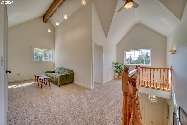 sitting room featuring carpet flooring, ceiling fan, beam ceiling, and high vaulted ceiling