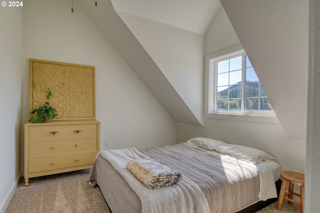 carpeted bedroom with a mountain view and lofted ceiling