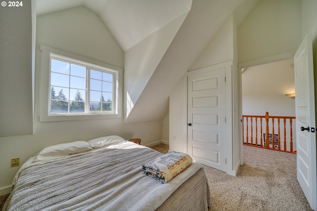 bedroom featuring light colored carpet and vaulted ceiling