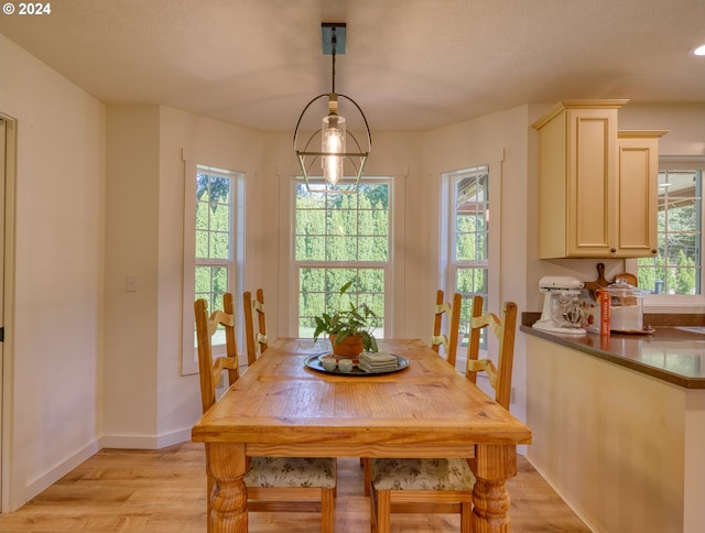 dining area with a notable chandelier and light wood-type flooring