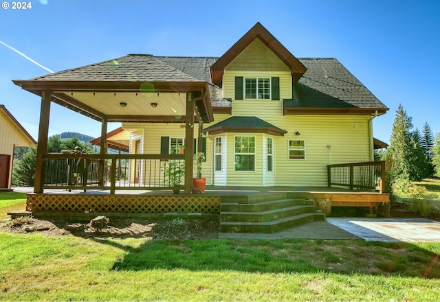 back of property with a lawn and a patio