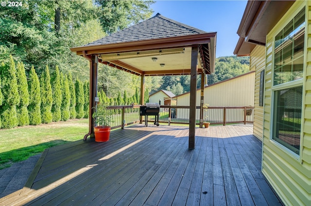 deck with grilling area and a lawn