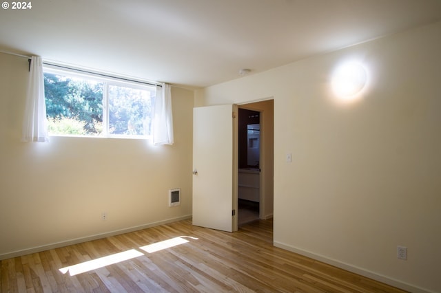 unfurnished room featuring light hardwood / wood-style flooring