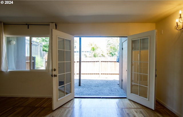 entryway with french doors and wood-type flooring